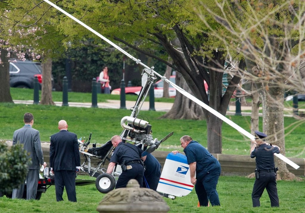 Capitol Hill police officers and other officials lift a gyrocopter that landed on the US Capitol South Lawn, on to a trailer, April 15, 2015, in Washington, DC. Capitol Hill police officers and other officials lift a gyrocopter that landed on the US Capitol South Lawn, on to a trailer, April 15, 2015, in Washington, DC.