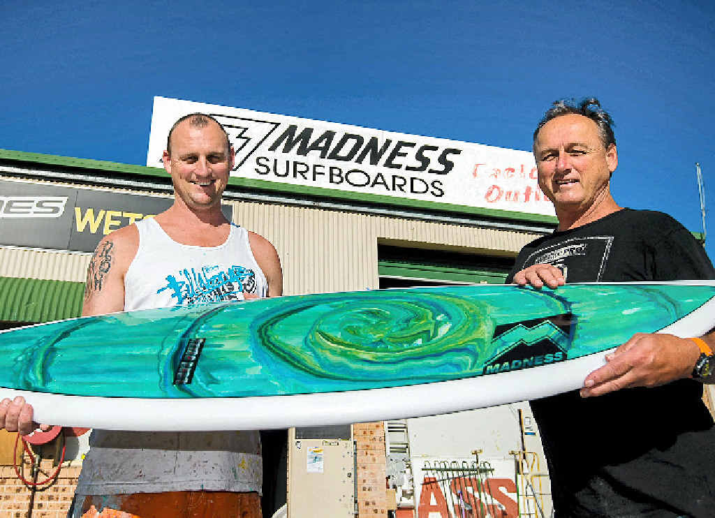 GOING STRONG: Madness Surfboards owner and shaper Chris Henry (right) and his son Byron have adapted to challenging market conditions. GOING STRONG: Madness Surfboards owner and shaper Chris Henry (right) and his son Byron have adapted to challenging market conditions.