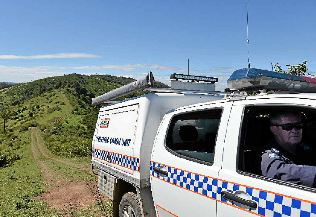 CRASH SCENE: A police Forensic Crash Unit vehicle makes its hazardous way from the almost inaccessible crash site near Woolooga yesterday CRASH SCENE: A police Forensic Crash Unit vehicle makes its hazardous way from the almost inaccessible crash site near Woolooga yesterday