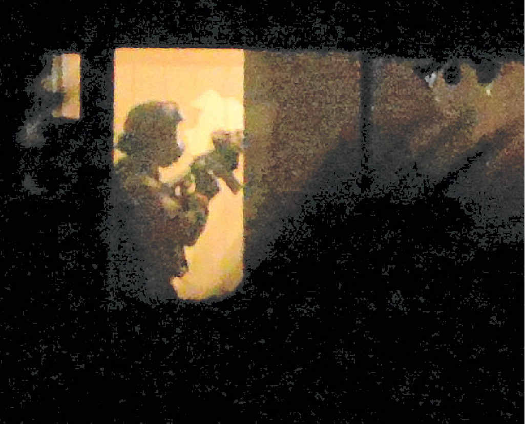 ENTRY: Police armed with military style weapons enter the house at the peak of Tuesday night’s drama ENTRY: Police armed with military style weapons enter the house at the peak of Tuesday night’s drama
