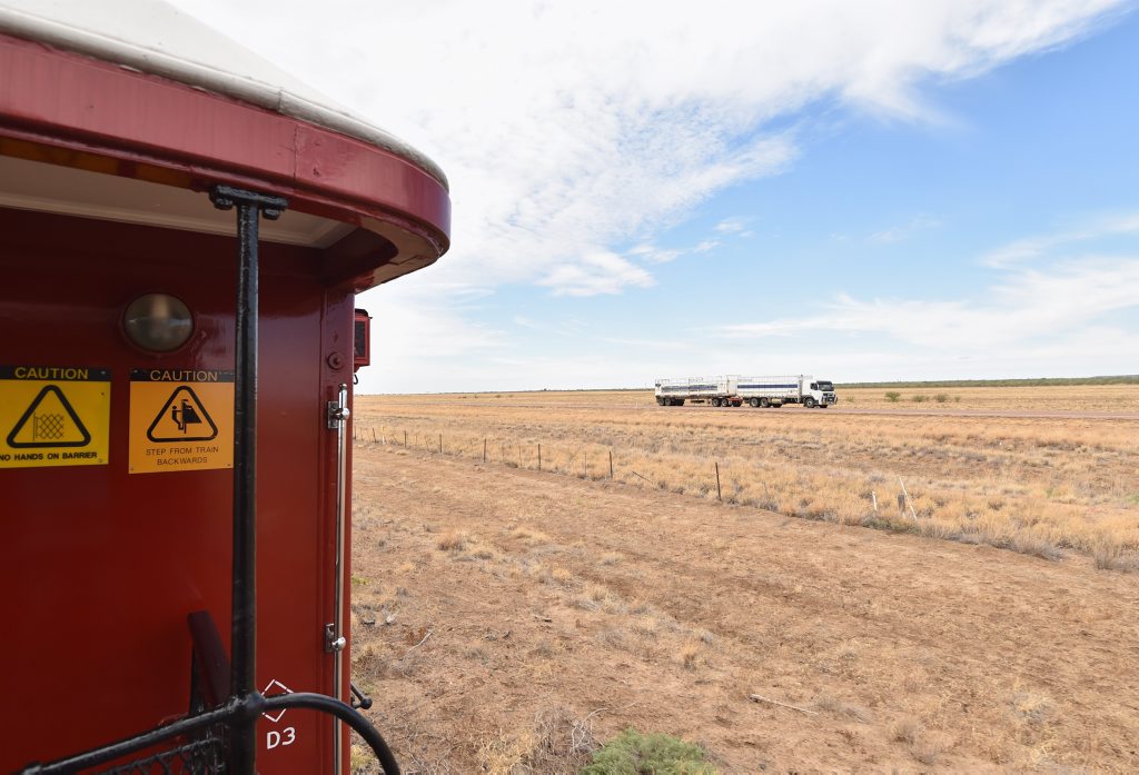 2015 Anzac Troop Train Re--enactment - Winton to Longreach. A semi-trailer passess the railway. Photo: Alistair Brightman / Fraser Coast Chronicle