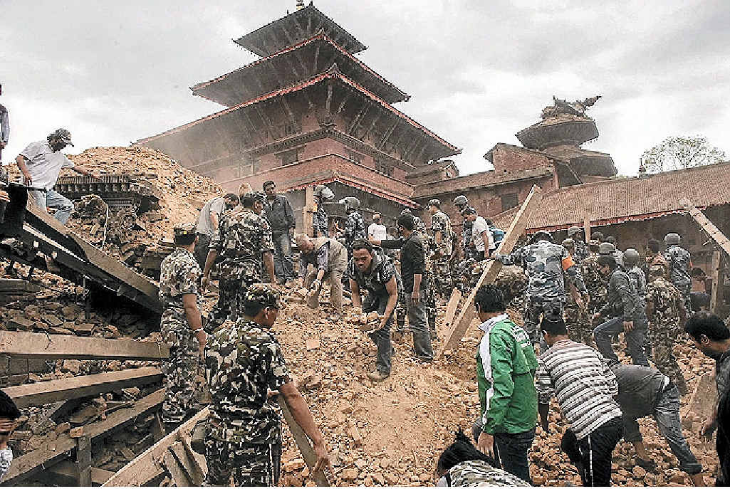 Rescue workers sifting through the ruins of a building, looking for survivors, after a devastating 7.8 magnitude earthquake shook Nepal on Saturday. Rescue workers sifting through the ruins of a building, looking for survivors, after a devastating 7.8 magnitude earthquake shook Nepal on Saturday.