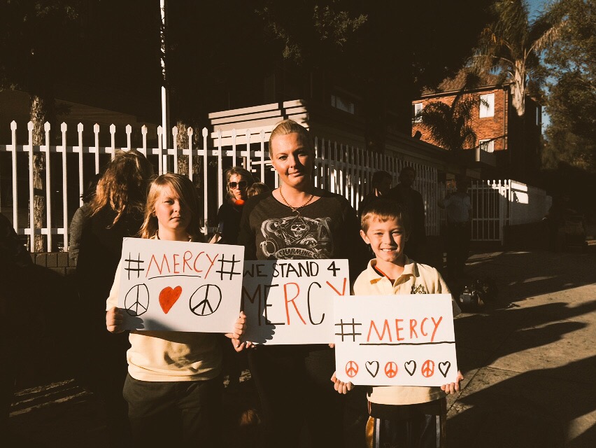 Crowds gather outside the Indonesian Consulate in Sydney calling for mercy.