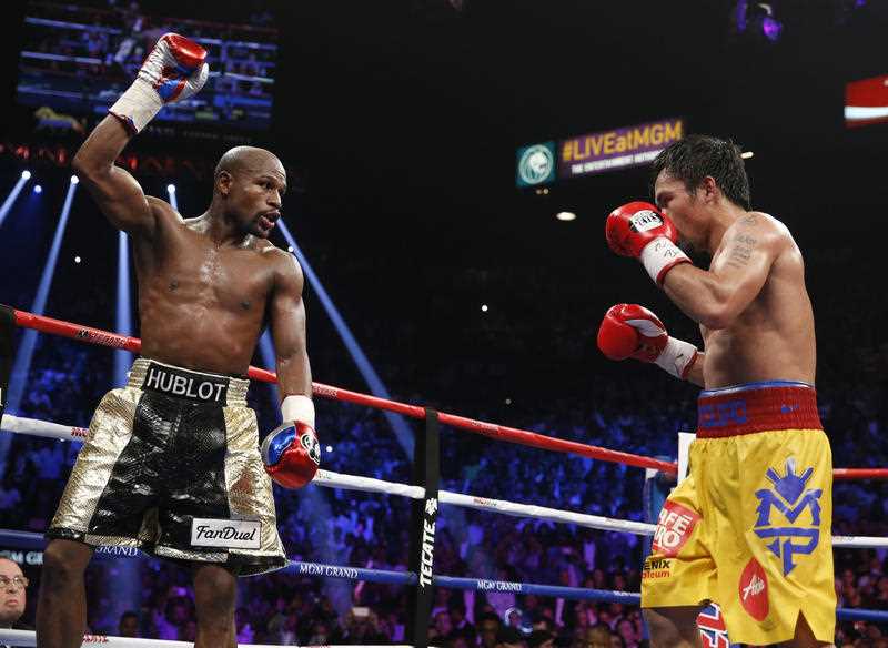Floyd Mayweather Jr., left, celebrates during his welterweight title fight against Manny Pacquiao, from the Philippines, on Saturday, May 2, 2015 in Las Vegas. Floyd Mayweather Jr., left, celebrates during his welterweight title fight against Manny Pacquiao, from the Philippines, on Saturday, May 2, 2015 in Las Vegas.