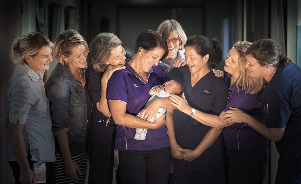 Grafton Base Hospital midwives Lee O'Shea, Laurel Moore, Susan Bewey, Katie Dobbin, Angie Garland, Sandy McCarthy, Marg Craemri and Bettina Almonda try to get a look at new arrival Michael Gudz, born on May 4. Photo Adam Hourigan / The Daily Examiner Grafton Base Hospital midwives Lee O'Shea, Laurel Moore, Susan Bewey, Katie Dobbin, Angie Garland, Sandy McCarthy, Marg Craemri and Bettina Almonda try to get a look at new arrival Michael Gudz, born on May 4. Photo Adam Hourigan / The Daily Examiner