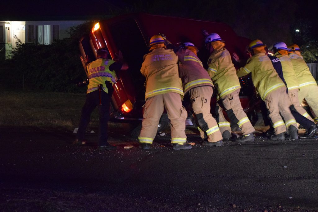 Firefighters work with police to right a four-wheel-drive that rolled at the corner of North and King streets. Firefighters work with police to right a four-wheel-drive that rolled at the corner of North and King streets.