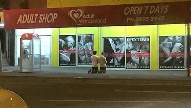 A photo posted on Reddit showing two men praying outside Annerley's Adult Wonderland last week. Photo: Reddit A photo posted on Reddit showing two men praying outside Annerley's Adult Wonderland last week. Photo: Reddit