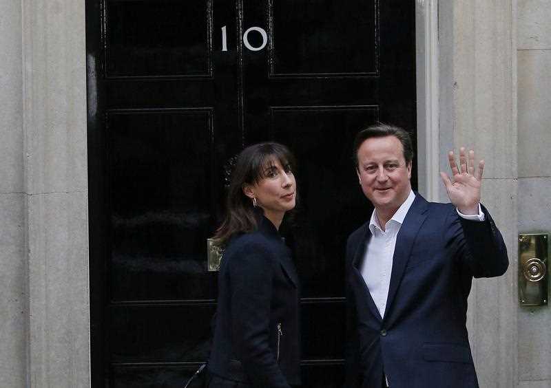 British Prime Minister and Leader of the Conservative Party David Cameron (R) and his wife Samantha are pictured as they arrive at 10 Downing Street in London on May 8, 2015, the day after a general election. British Prime Minister and Leader of the Conservative Party David Cameron (R) and his wife Samantha are pictured as they arrive at 10 Downing Street in London on May 8, 2015, the day after a general election.