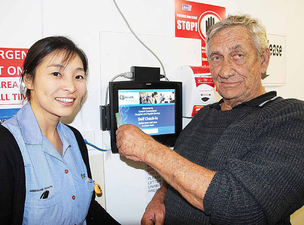 NEW KIOSKS: Minjung Jang shows Neville Thring how to swipe his Medicare card to check in for his specialist appointment at Rockhampton Hospital. Mr Thring has regular appointments at the hospital and he appreciates no longer having to stand in a long queue on arrival. NEW KIOSKS: Minjung Jang shows Neville Thring how to swipe his Medicare card to check in for his specialist appointment at Rockhampton Hospital. Mr Thring has regular appointments at the hospital and he appreciates no longer having to stand in a long queue on arrival.