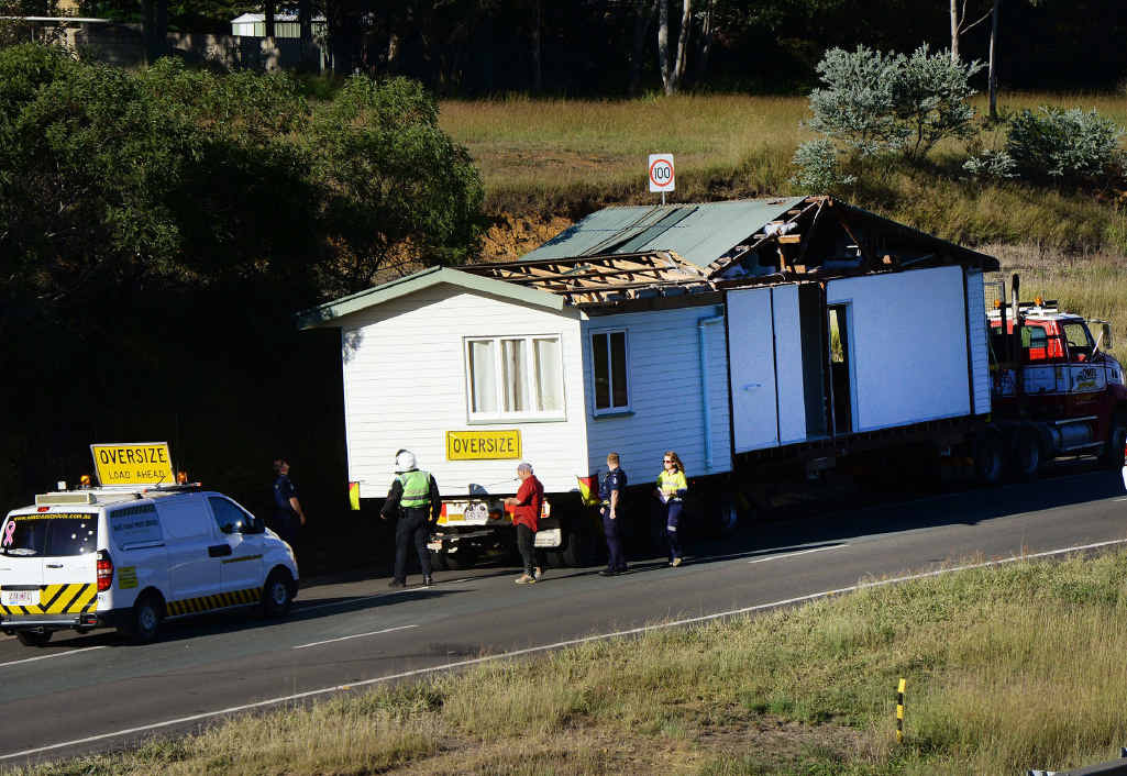 TIGHT SQUEEZE: A large traffic jam was created on the Cunningham Highway earlier this week when a truck carrying a house became stuck against roadworks barricades. TIGHT SQUEEZE: A large traffic jam was created on the Cunningham Highway earlier this week when a truck carrying a house became stuck against roadworks barricades.