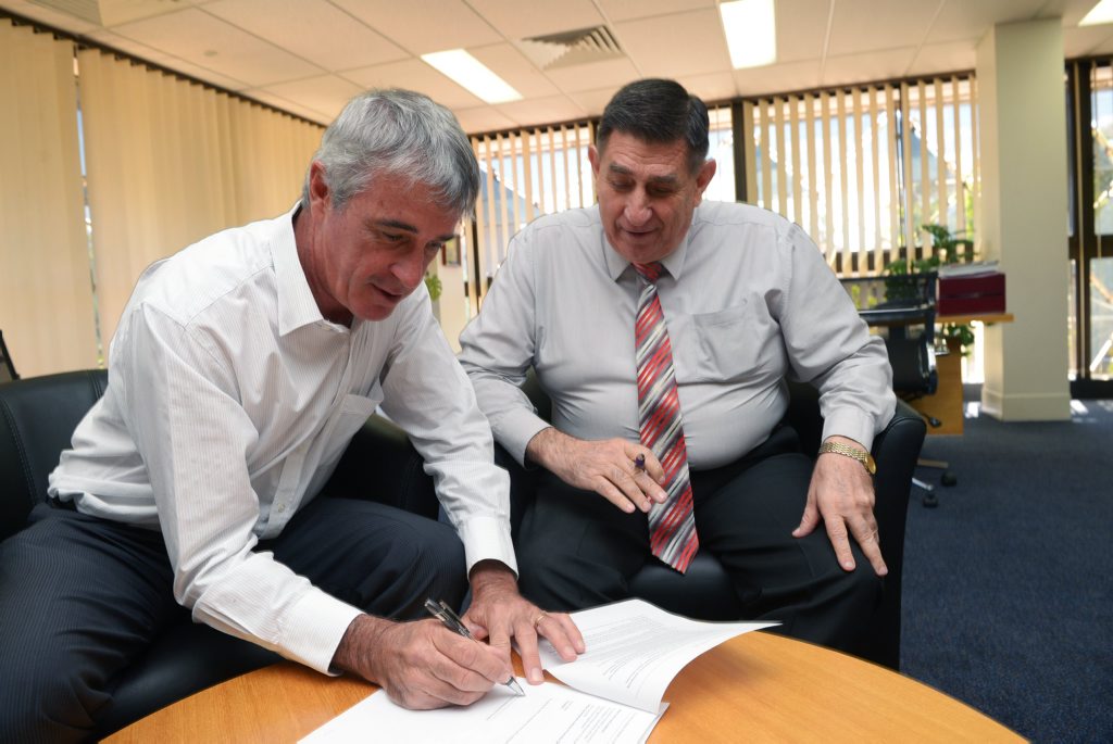 ONGOING ROLE: Bill Moorhead signs his UDIA letter of appointment to the role of president, witnessed by Bundaberg Mayor Mal Forman. Photo taken on Thursday, 14 May 2015. Photo: Max Fleet / NewsMail ONGOING ROLE: Bill Moorhead signs his UDIA letter of appointment to the role of president, witnessed by Bundaberg Mayor Mal Forman. Photo taken on Thursday, 14 May 2015. Photo: Max Fleet / NewsMail