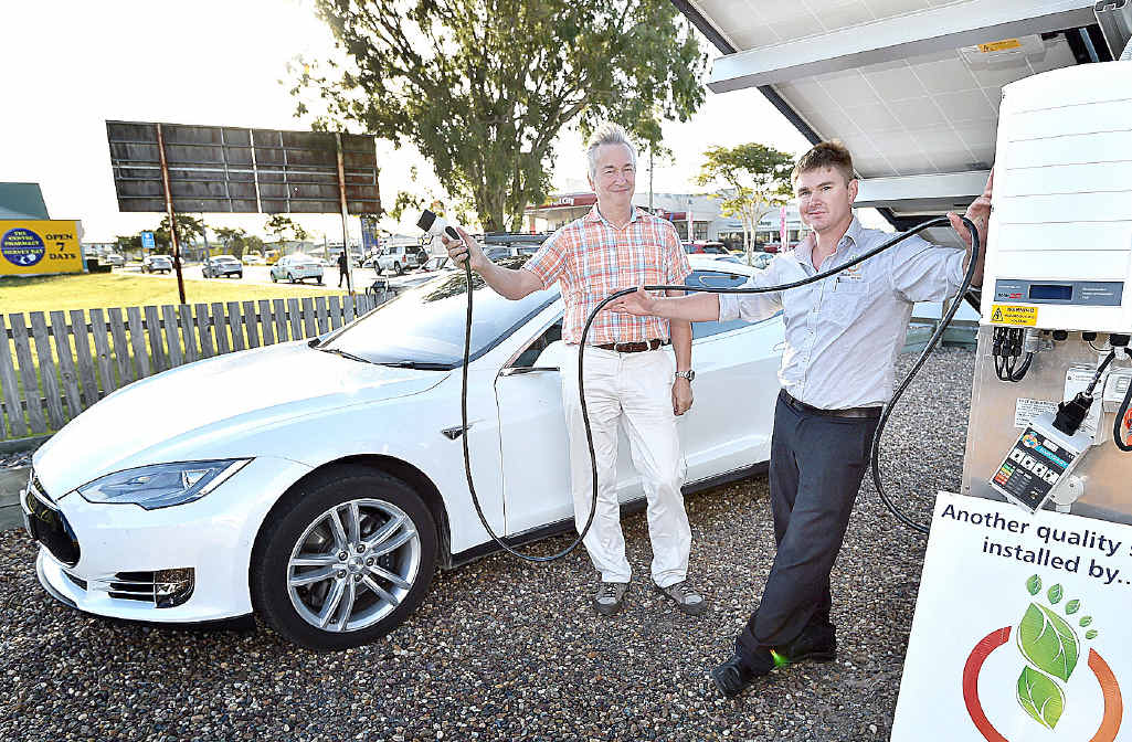 ELECTRIC CAR: Marc Talloen (left) is about to refuel his Tesla car with renewable solar energy while Toby Hunter, from Solar Power Wide Bay Burnett, is happy to assist him. ELECTRIC CAR: Marc Talloen (left) is about to refuel his Tesla car with renewable solar energy while Toby Hunter, from Solar Power Wide Bay Burnett, is happy to assist him.