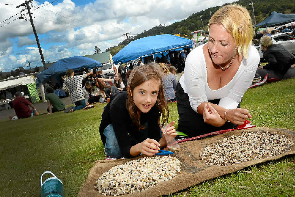 DIGGING IT: Tash Kernahan and daughter Hannah, 8, try their luck fossicking at Gemfest in Lismore. DIGGING IT: Tash Kernahan and daughter Hannah, 8, try their luck fossicking at Gemfest in Lismore.