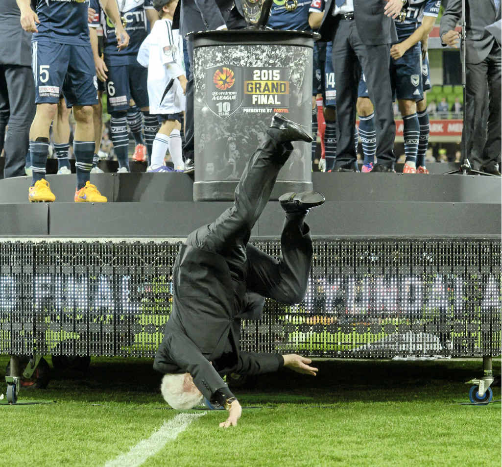 TAKING A DIVE: Football Federation Australian chairman Frank Lowy falls off the stage. TAKING A DIVE: Football Federation Australian chairman Frank Lowy falls off the stage.