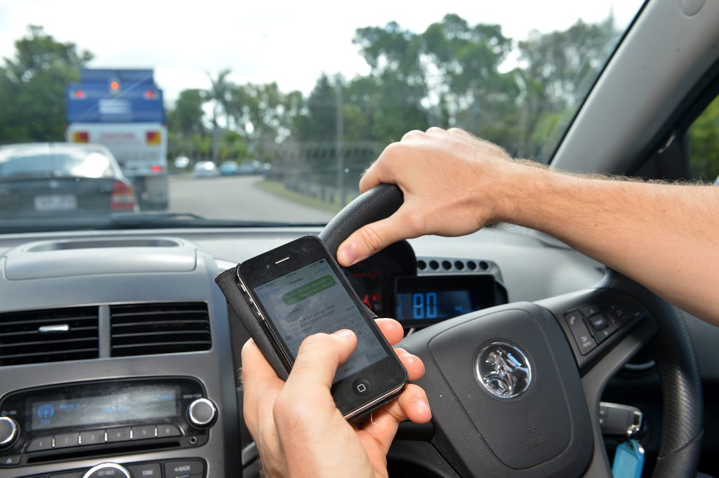 Texting while driving. Photo: Warren Lynam / Sunshine Coast Daily Texting while driving. Photo: Warren Lynam / Sunshine Coast Daily