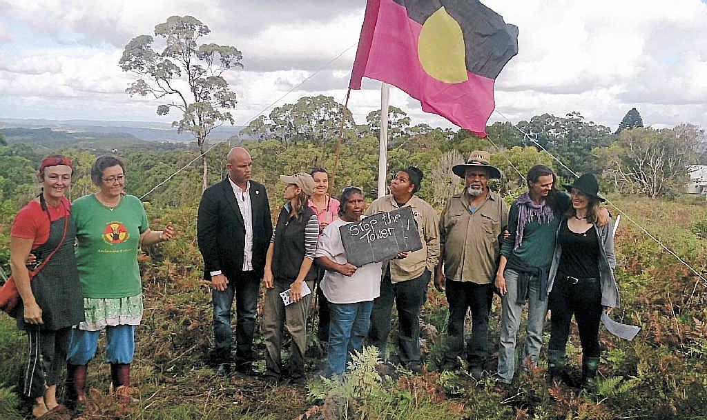 VOW TO FIGHT: Members of the Dorrobbee Grass Resreve Trust and the Ngulingah Aboriginal Land Council raise a flag to protest the construction of a mobile phone tower just outside Dunoon. VOW TO FIGHT: Members of the Dorrobbee Grass Resreve Trust and the Ngulingah Aboriginal Land Council raise a flag to protest the construction of a mobile phone tower just outside Dunoon.