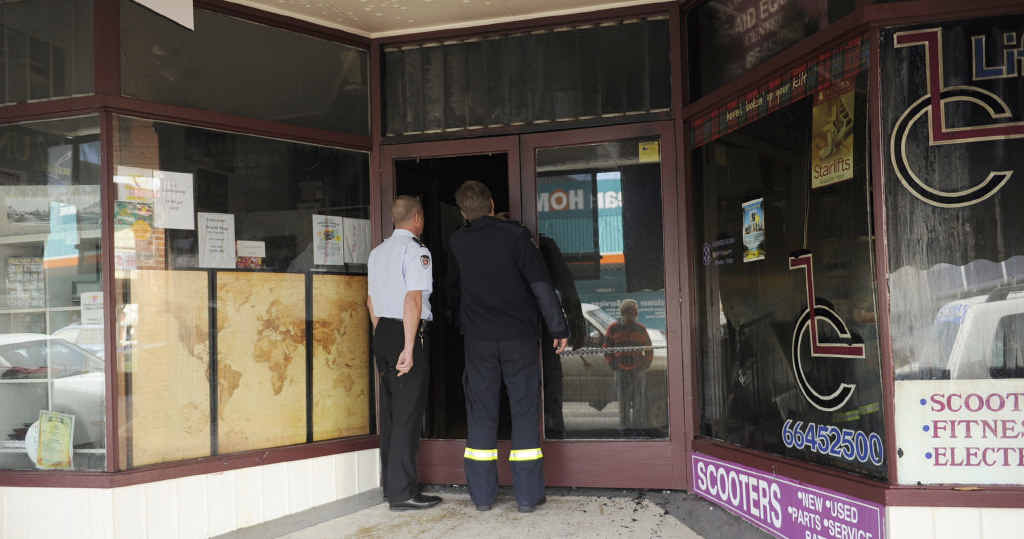 BURNT OUT: Fire investigators look through Cameron’s Arcade in River Street, Maclean, where a fire ripped through on Saturday night, gutting the arcade and taking out four shops. Photo: Debrah Novak BURNT OUT: Fire investigators look through Cameron’s Arcade in River Street, Maclean, where a fire ripped through on Saturday night, gutting the arcade and taking out four shops. Photo: Debrah Novak