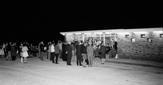 The $100,000 drive-in theatre was situated on a 16 acre site about eight kilometres south of Nambour at the Maroochydore turn-off. Owned by M. Stewart and A.S. Townsend of Buderim, the drive-in had a 350 car capacity and included a restaurant, admissions building, projection room and children's playground. It screened six nights a week.
Photo Courtesy of Sunshine Coast Council’s Heritage Library The $100,000 drive-in theatre was situated on a 16 acre site about eight kilometres south of Nambour at the Maroochydore turn-off. Owned by M. Stewart and A.S. Townsend of Buderim, the drive-in had a 350 car capacity and included a restaurant, admissions building, projection room and children's playground. It screened six nights a week.
Photo Courtesy of Sunshine Coast Council’s Heritage Library