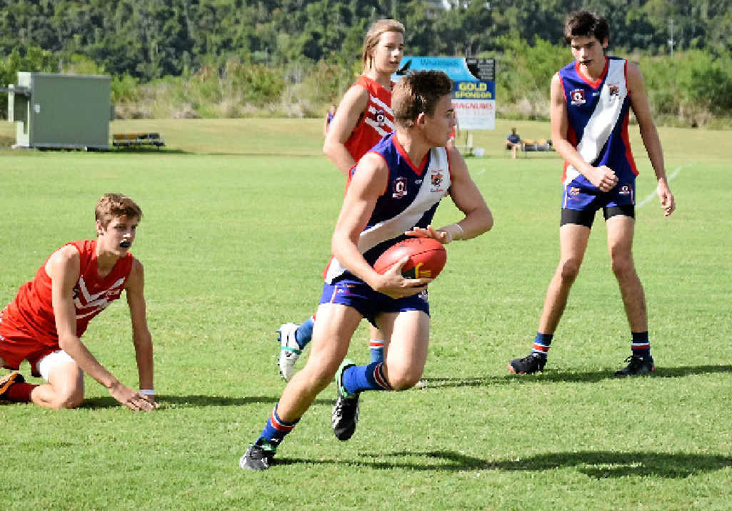 GAME ON: Sea Eagle Layton McGregor outruns Eastern Swans’ players during Saturday afternoon’s match. Photo Charlotte Lam / Whitsunday Times GAME ON: Sea Eagle Layton McGregor outruns Eastern Swans’ players during Saturday afternoon’s match. Photo Charlotte Lam / Whitsunday Times