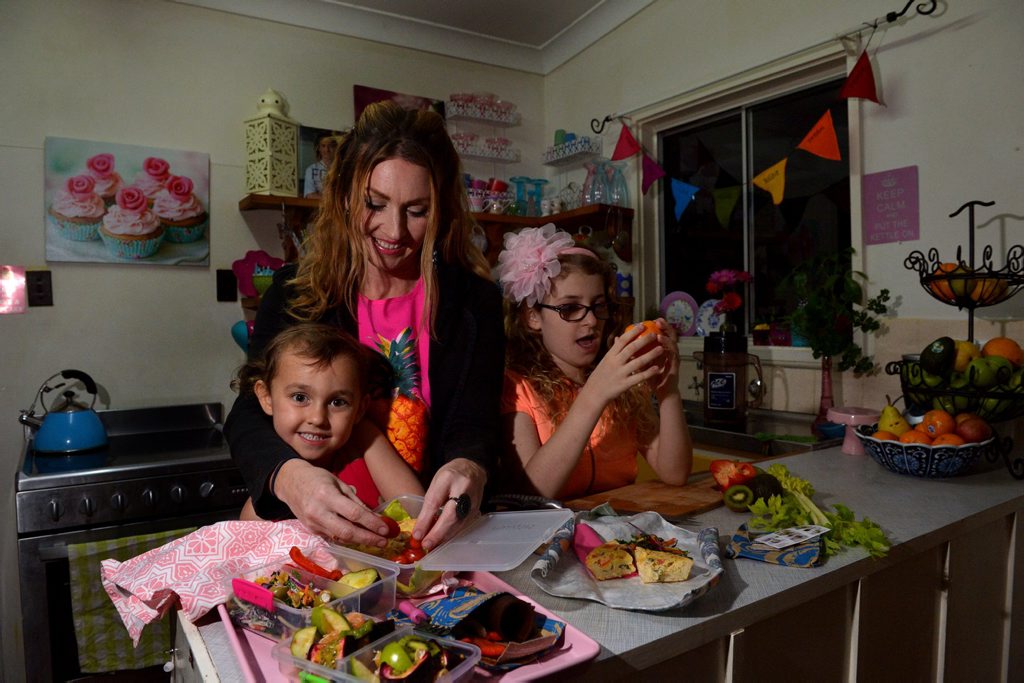 Image for sale: Bek Mugridge with her children Lily, 9 and Violet Teubler, 4 are content if their lunch boxes are checked at school. Photo: John McCutcheon / Sunshine Coast Daily