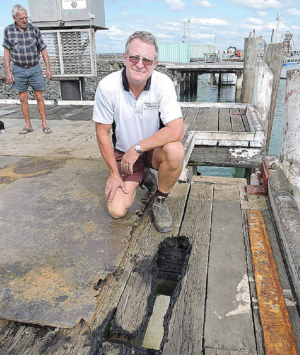 DIRTY WORK: Russell Clark inspects the damage. DIRTY WORK: Russell Clark inspects the damage.