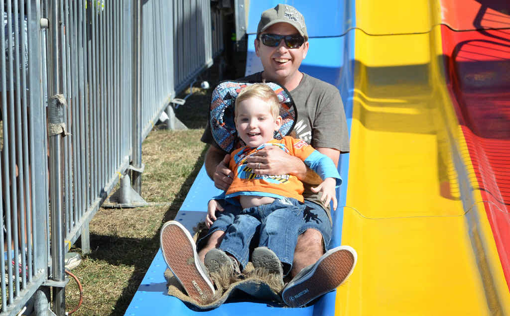 FATHER SON DAY: Craig Thwaite with son Hayden enjoying the big slide in Sideshow Alley. FATHER SON DAY: Craig Thwaite with son Hayden enjoying the big slide in Sideshow Alley.