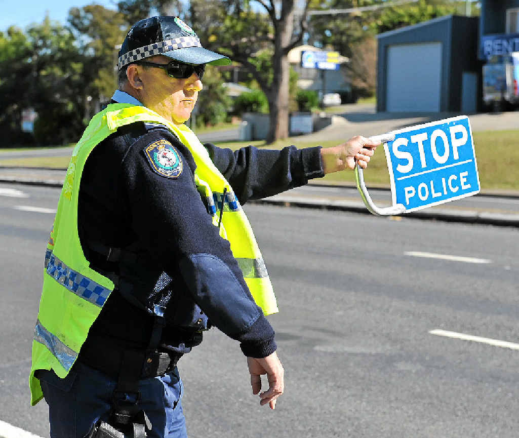 STAY ALERT: Highway patrol Sergeant Craig Enchelmaier flags traffic during the blitz. STAY ALERT: Highway patrol Sergeant Craig Enchelmaier flags traffic during the blitz.
