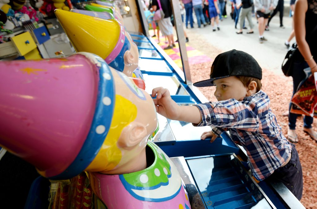 Three year old Olivar Healy tries his luck at the sideshow alley. Photo Allan Reinikka / The Morning Bulletin Three year old Olivar Healy tries his luck at the sideshow alley. Photo Allan Reinikka / The Morning Bulletin
