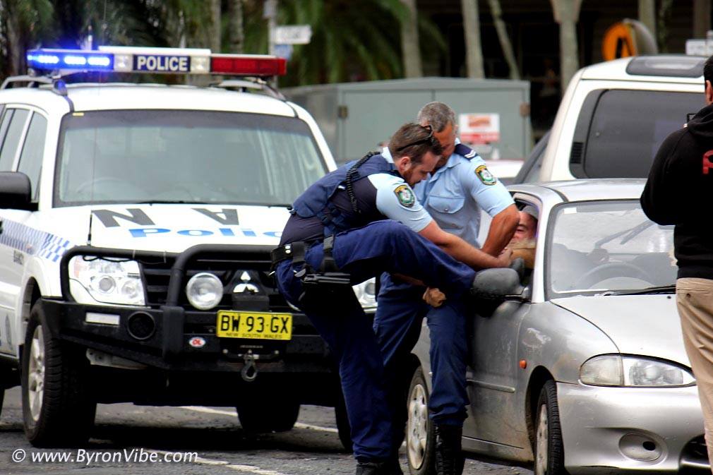 An image supplied by Trevor Avedissian showing police pulling a man through the smashed window of his car during an arrest at Mullumbimby. An image supplied by Trevor Avedissian showing police pulling a man through the smashed window of his car during an arrest at Mullumbimby.