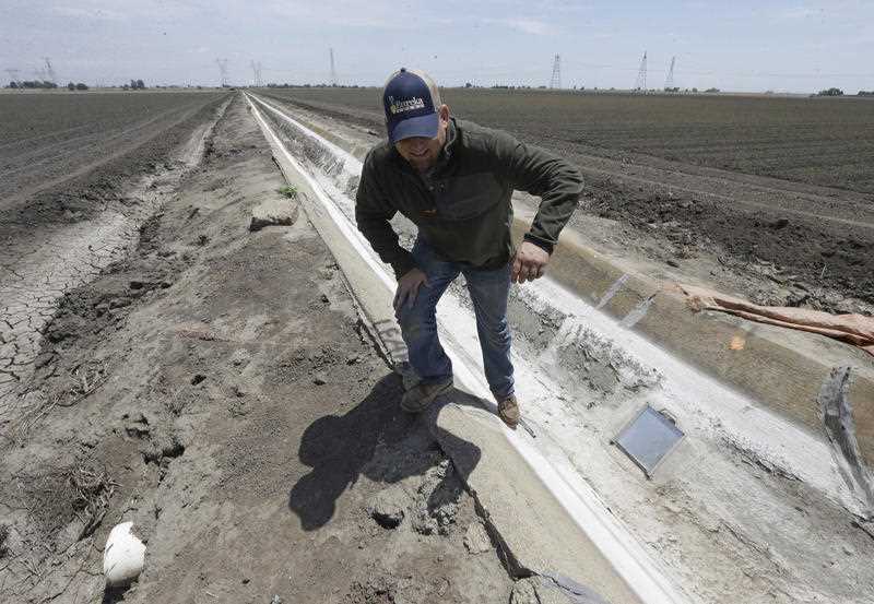 Gino Celli climbs out of an irrigation canal that is covered in dried salt on a field he farms near Stockton, Calif. California, grappling with drought, exacted the broadest water cuts on record Gino Celli climbs out of an irrigation canal that is covered in dried salt on a field he farms near Stockton, Calif. California, grappling with drought, exacted the broadest water cuts on record