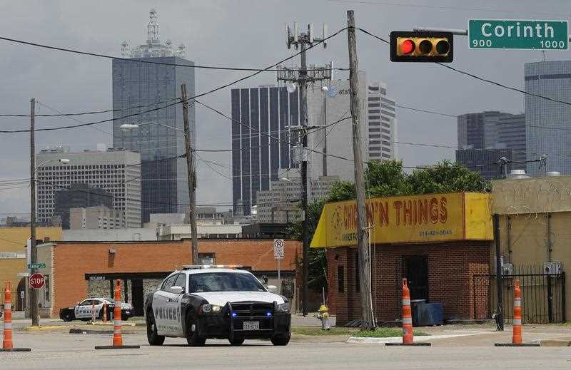 A Dallas Police cruiser blocks Lamar Street near The Dallas Police Headquarters building where there was a confrontation with James Boulware who was later shot by a Dallas Police sniper. A Dallas Police cruiser blocks Lamar Street near The Dallas Police Headquarters building where there was a confrontation with James Boulware who was later shot by a Dallas Police sniper.