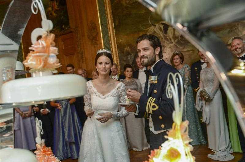 Sweden's Prince Carl Philip, center right, and Sofia Hellqvist , center left, smile after cutting the wedding cake during their wedding in the royal place in Stockholm, Saturday, June 13, 2015 Sweden's Prince Carl Philip, center right, and Sofia Hellqvist , center left, smile after cutting the wedding cake during their wedding in the royal place in Stockholm, Saturday, June 13, 2015