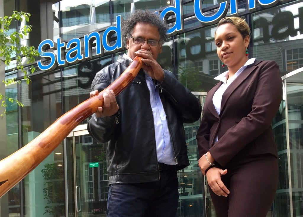 Murrawah Johnson and Adrian Burragubba outside Standard Chartered bank in London during their international trip urging the world's biggest banks not to fund Adani's Carmichael Mine project in the Galilee Basin. Murrawah Johnson and Adrian Burragubba outside Standard Chartered bank in London during their international trip urging the world's biggest banks not to fund Adani's Carmichael Mine project in the Galilee Basin.