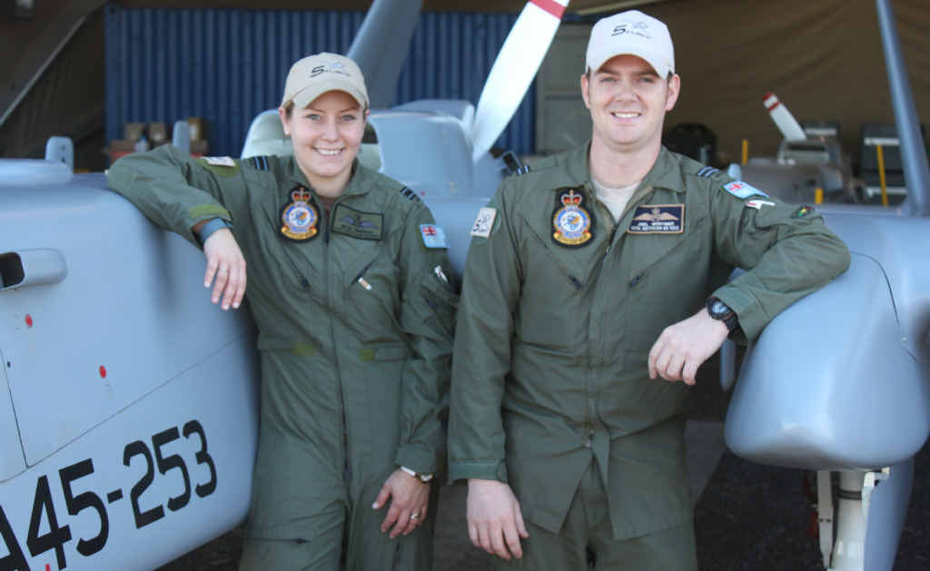 FLYING HIGH: Flight Lieutenant Janelle Sheridan and Flight Lieutenant Joel Mortimer with the Heron remotely piloted Unmanned Aircraft System, which will be flown in civilian airspace for the first time next week.