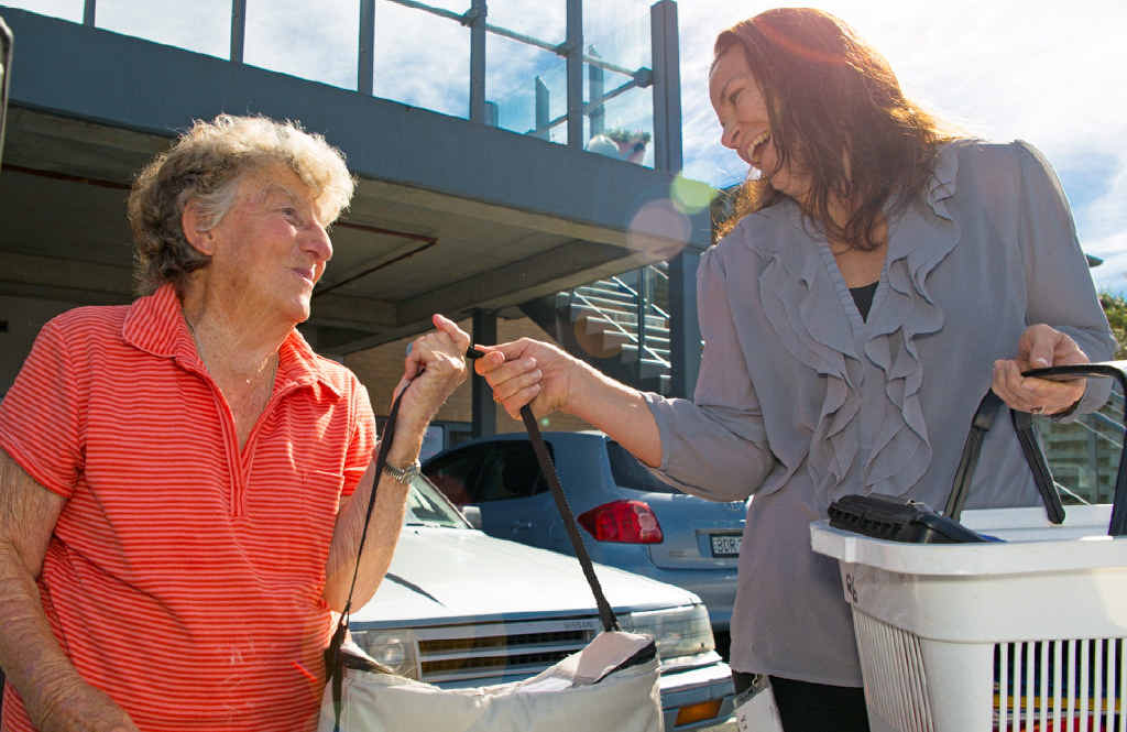 HERE TO HELP: Volunteer Joan picks up meals from staff member Vic in preparation for her delivery run. Gemima Harvey HERE TO HELP: Volunteer Joan picks up meals from staff member Vic in preparation for her delivery run. Gemima Harvey