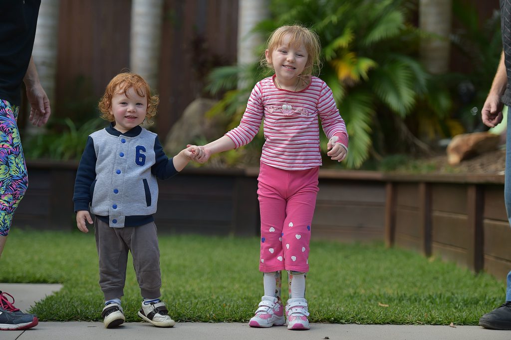 Cayden Cox-Bowden helps his sister Jameela learn to walk. Cayden Cox-Bowden helps his sister Jameela learn to walk.