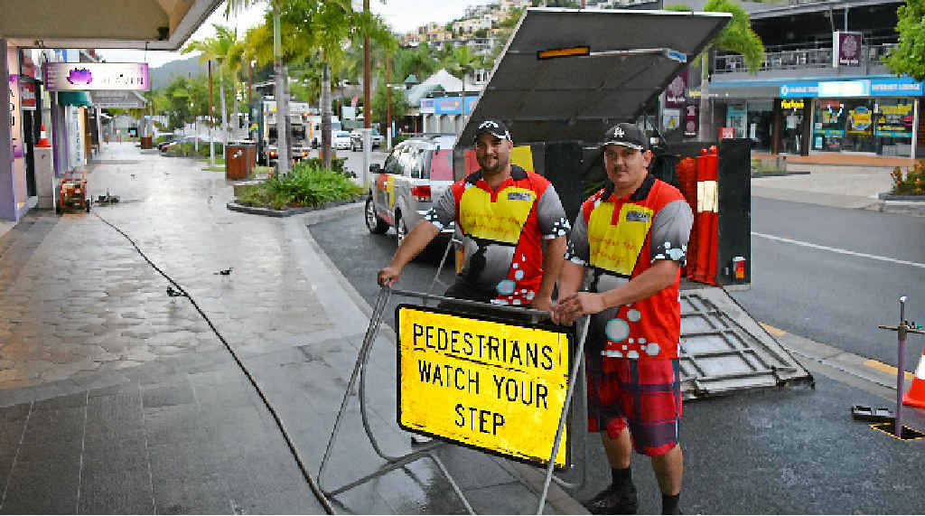 KEEPING CLEAN: Mick Leo and Malcolm Thompson from Etwell Commercial Cleaning on the Airlie Beach main street on Monday morning. Photo: Charlotte Lam KEEPING CLEAN: Mick Leo and Malcolm Thompson from Etwell Commercial Cleaning on the Airlie Beach main street on Monday morning. Photo: Charlotte Lam