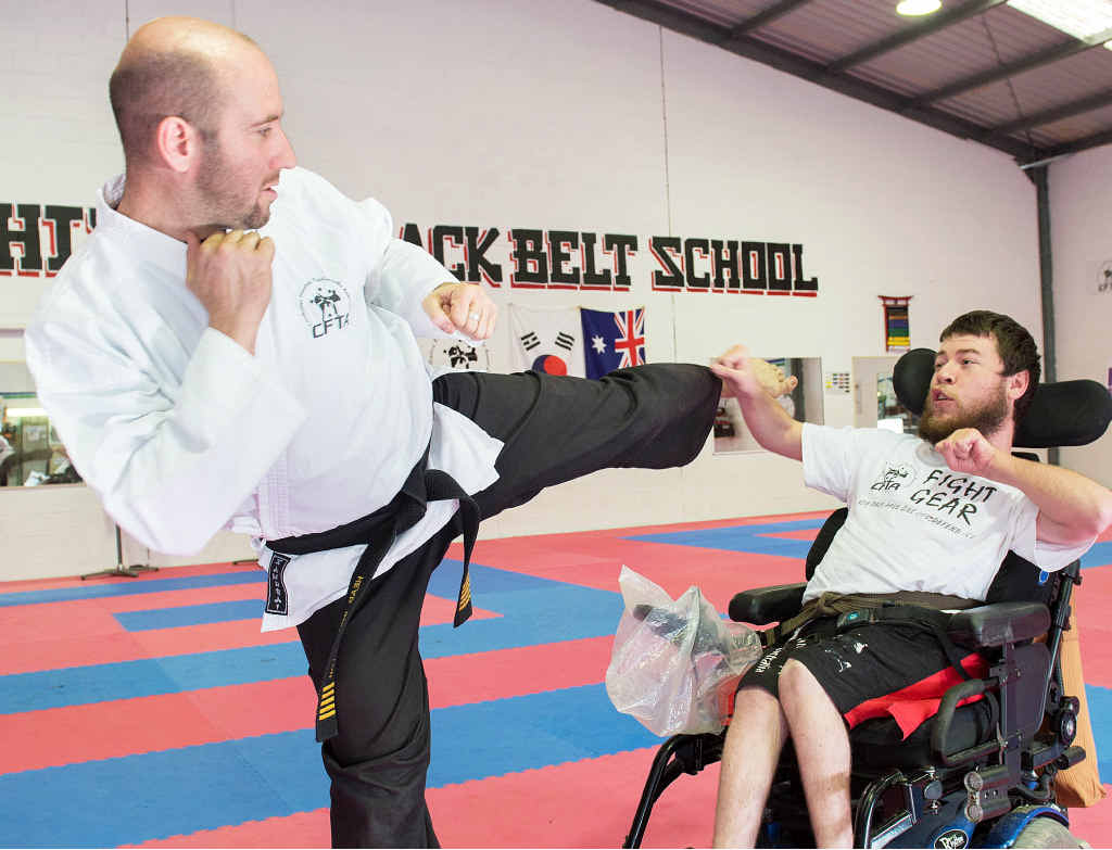 SMASHING BARRIERS: Luke Fieldhouse, who has cerebral palsy, with tae kwon do instructor Master Michael Landas. Trevor Veale SMASHING BARRIERS: Luke Fieldhouse, who has cerebral palsy, with tae kwon do instructor Master Michael Landas. Trevor Veale