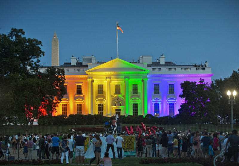 People gather in Lafayette Park to see the White House illuminated with rainbow colors in commemoration of the Supreme Court's ruling to legalize same-sex marriage in Washington. People gather in Lafayette Park to see the White House illuminated with rainbow colors in commemoration of the Supreme Court's ruling to legalize same-sex marriage in Washington.