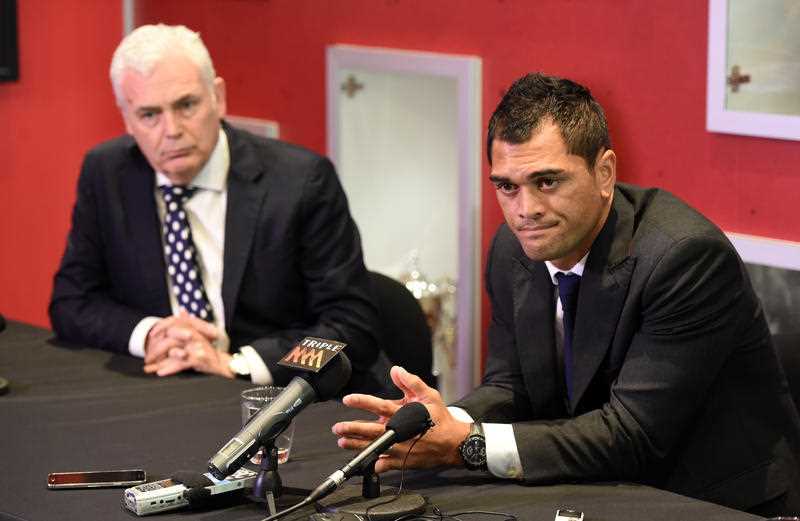 Queensland Reds player Karmichael Hunt (right) is watched by the club's CEO Jim Carmichael during a press conference at the Reds headquarters in Brisbane. Queensland Reds player Karmichael Hunt (right) is watched by the club's CEO Jim Carmichael during a press conference at the Reds headquarters in Brisbane.