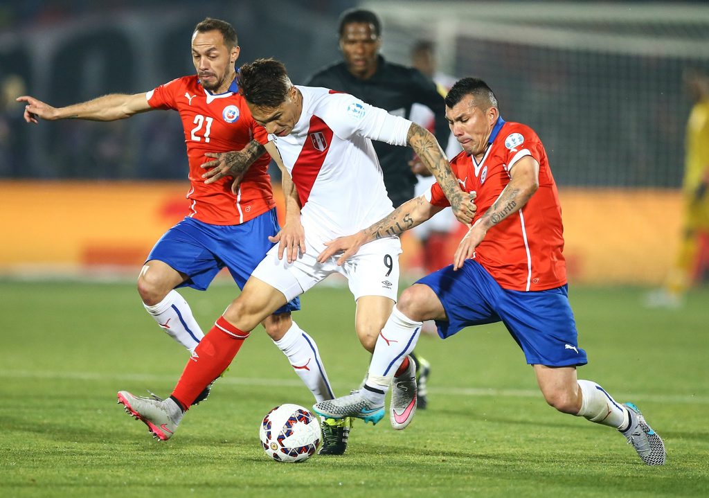 Chile's Marcelo Diaz, left, and Gary Medel, right, challenge Peru's Jose Guerrero, center, during the Copa America 2015 semi-final soccer match between Chile and Peru at the National Stadium in Santiago, Chile, 29 June 2015. Chile qualified for the Copa America final on Monday (29 June 2015) after two goals from Eduardo Vargas gave them a 2-1 win over Peru in an action-packed semi-final marked by another controversial refereeing decision. Peru had to play with 10 men for most of the match after Carlos Zambrano, who was yellow carded in the seventh minute, was harshly sent off for a high challenge 13 minutes later. Chile got the opener on 42 minutes when Vargas managed to poke the ball home from three yards after an Alexis Sanchez cross had come back off the post. Television replays showed him to be marginally offside. Peru equalised on the hour mark when Paolo Guerrero split the Chilean defence with a pass for Luis Advincula and his vicious cross was turned into his own net by Gary Medel. Peru's lead lasted just four minutes, though, and again it was Vargas who got Chile's goal, lashing home an unstoppable strike from 30 yards. Chile's Marcelo Diaz, left, and Gary Medel, right, challenge Peru's Jose Guerrero, center, during the Copa America 2015 semi-final soccer match between Chile and Peru at the National Stadium in Santiago, Chile, 29 June 2015. Chile qualified for the Copa America final on Monday (29 June 2015) after two goals from Eduardo Vargas gave them a 2-1 win over Peru in an action-packed semi-final marked by another controversial refereeing decision. Peru had to play with 10 men for most of the match after Carlos Zambrano, who was yellow carded in the seventh minute, was harshly sent off for a high challenge 13 minutes later. Chile got the opener on 42 minutes when Vargas managed to poke the ball home from three yards after an Alexis Sanchez cross had come back off the post. Television replays showed him to be marginally offside. Peru equalised on the hour mark when Paolo Guerrero split the Chilean defence with a pass for Luis Advincula and his vicious cross was turned into his own net by Gary Medel. Peru's lead lasted just four minutes, though, and again it was Vargas who got Chile's goal, lashing home an unstoppable strike from 30 yards.