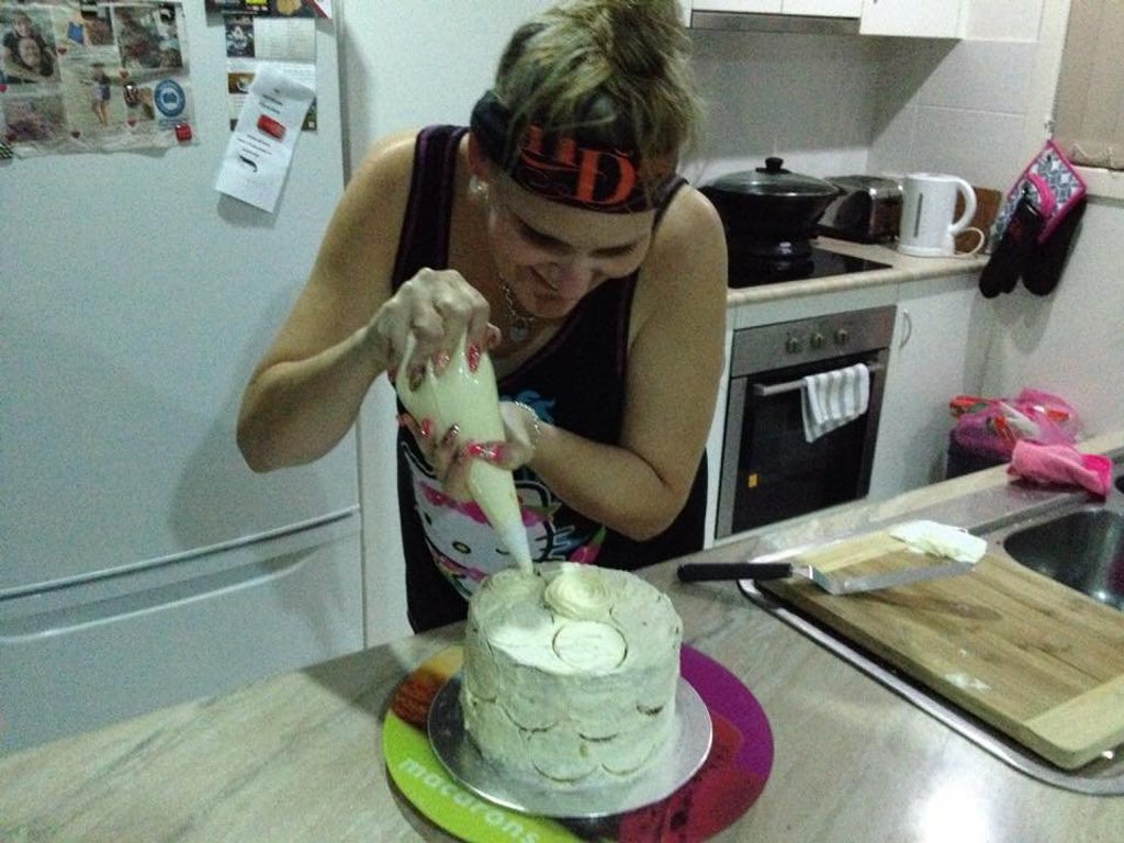Angie Smith in the process of making the Recipes + black and white layered sponge cake. 