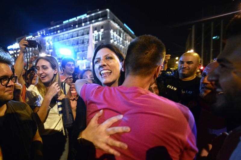 Greek parliament's president and Syriza party member, Zoe Kostantopoulou (C) embraces a 'NO' supporter , as she joins the celebrations in front of the parliament latein Athens on July 5, 2015. Greece's Prime Minister Alexis Tsipras said that the 'No' victory in the country's bailout referendum did not mean Athens was headed for a so-called Grexit. Greek parliament's president and Syriza party member, Zoe Kostantopoulou (C) embraces a 'NO' supporter , as she joins the celebrations in front of the parliament latein Athens on July 5, 2015. Greece's Prime Minister Alexis Tsipras said that the 'No' victory in the country's bailout referendum did not mean Athens was headed for a so-called Grexit.