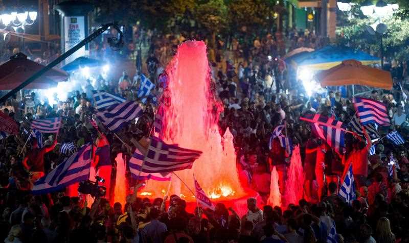 Supporters of the Syriza party and No vote campaign wave flags and react after results of the referendum in front of Greek Parliament in central Athens, Greece, 05 July 2015. Greek voters in the referendum were asked whether the country should accept reform proposals made by its creditors. Supporters of the Syriza party and No vote campaign wave flags and react after results of the referendum in front of Greek Parliament in central Athens, Greece, 05 July 2015. Greek voters in the referendum were asked whether the country should accept reform proposals made by its creditors.