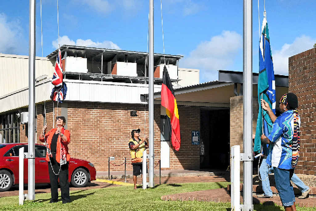CELEBRATION: Cr Jan Clifford, Nagro Gia traditional elder Sue West and Larissa Jeffrey raise the Australian, Aboriginal and Torres Strait Islander flags on Monday morning. CELEBRATION: Cr Jan Clifford, Nagro Gia traditional elder Sue West and Larissa Jeffrey raise the Australian, Aboriginal and Torres Strait Islander flags on Monday morning.