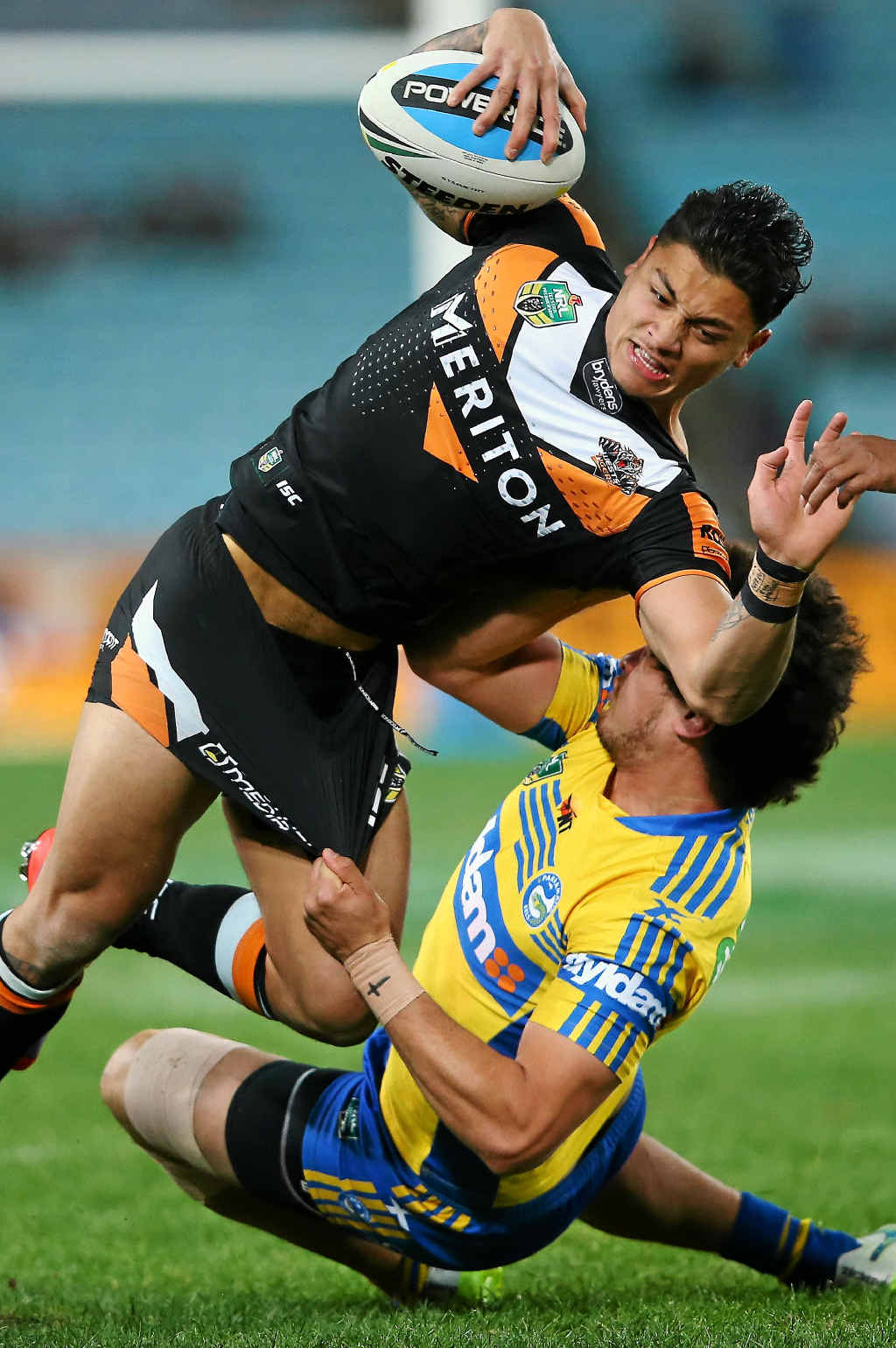 UP AND OVER: Delouise Hoeter of the Wests Tigers is tackled by Brad Takairangi of the Eels. UP AND OVER: Delouise Hoeter of the Wests Tigers is tackled by Brad Takairangi of the Eels.