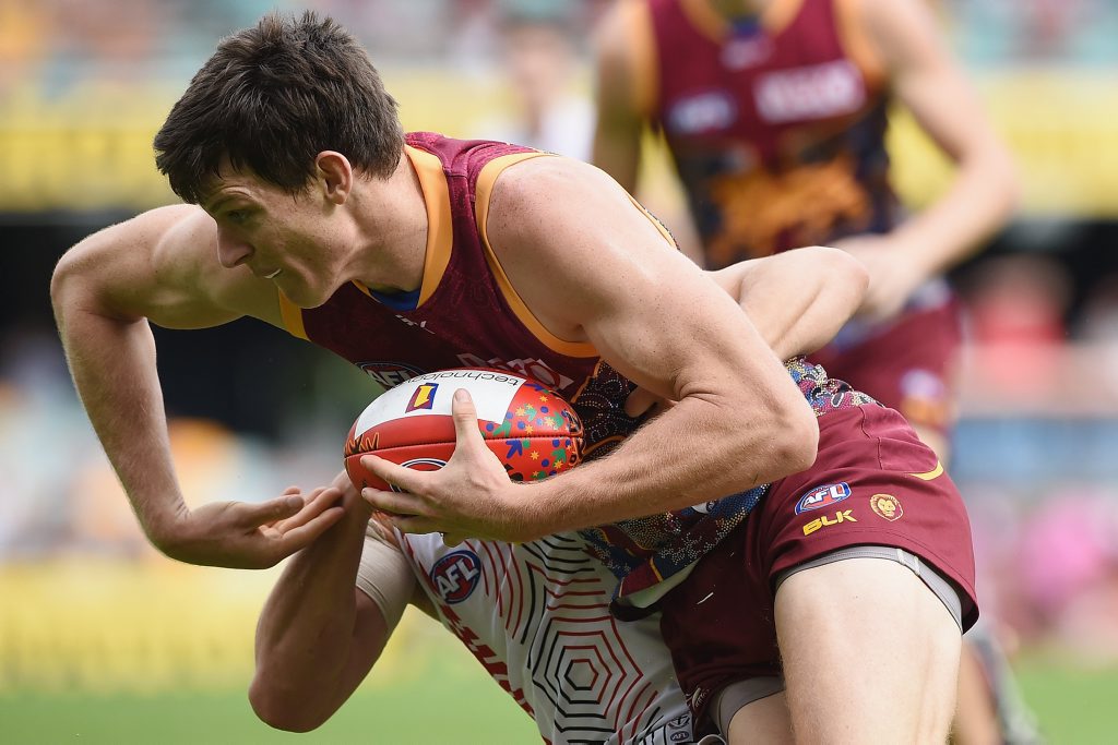 Justin Clarke of the Lions is tackled by Luke Dunstan of the Saints during the round 9 AFL match between the Brisbane Lions and St Kilda Saints at The Gabba in Brisbane, Sunday, May 31, 2015. (AAP Image/Matt Roberts) NO ARCHIVING, EDITORIAL USE ONLY. Justin Clarke of the Lions is tackled by Luke Dunstan of the Saints during the round 9 AFL match between the Brisbane Lions and St Kilda Saints at The Gabba in Brisbane, Sunday, May 31, 2015. (AAP Image/Matt Roberts) NO ARCHIVING, EDITORIAL USE ONLY.