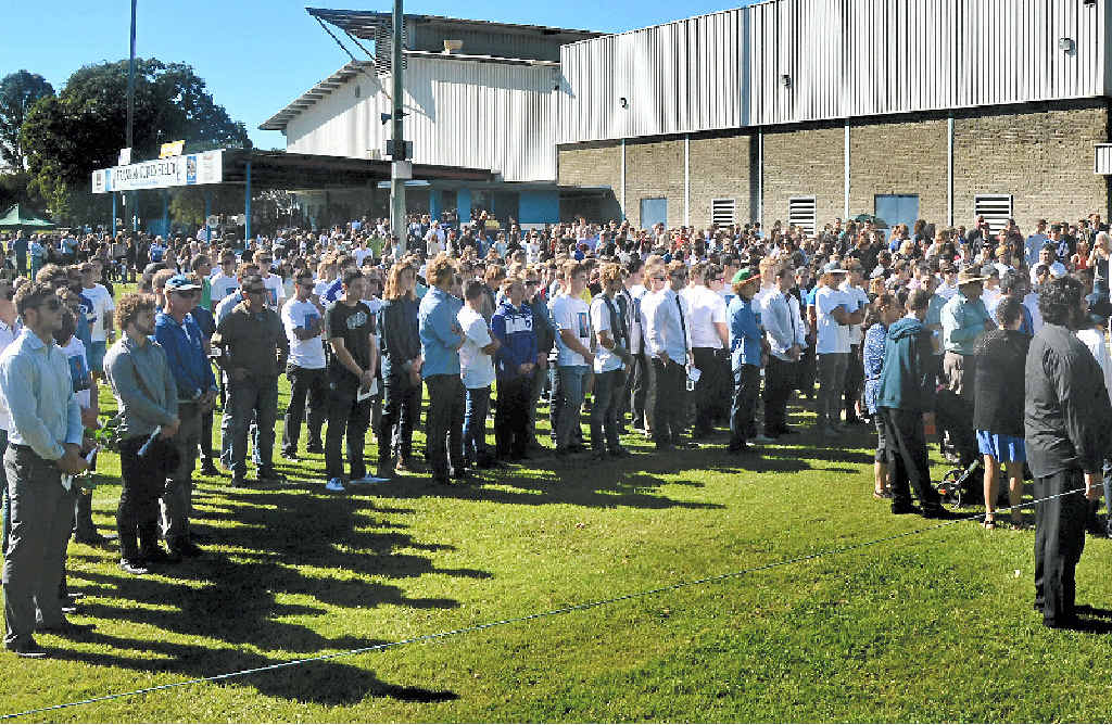 FAREWELL: Mourners watch on as the hearse carrying Clinton McGrail-Skinner departs from Frank McGuren Field in a police escort. Photo Matthew Elkerton FAREWELL: Mourners watch on as the hearse carrying Clinton McGrail-Skinner departs from Frank McGuren Field in a police escort. Photo Matthew Elkerton