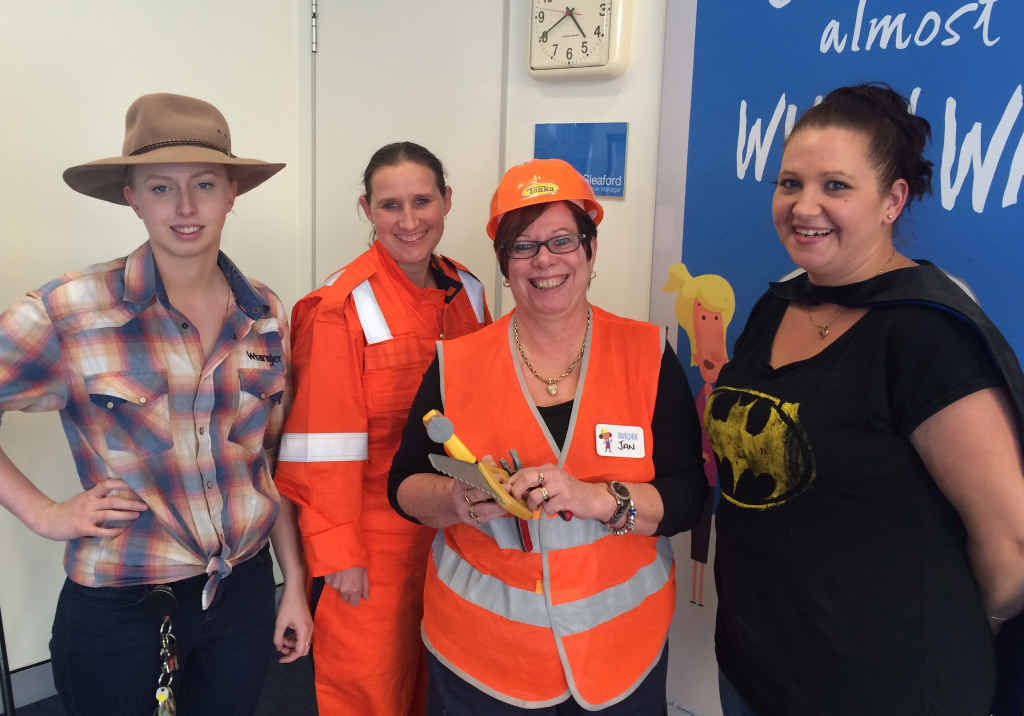 GROWING UP: Lauren Burgess, Allyson Brannigan, Jan Perriman and Nicole Murphy don costumes as part of BOQ North Rockhampton’s Banking on our Kids dress-up day.
