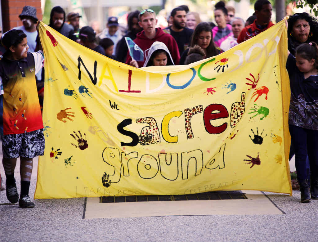 NAIDOC PRIDE: Young children proudly lead the parade with the banner. NAIDOC PRIDE: Young children proudly lead the parade with the banner.